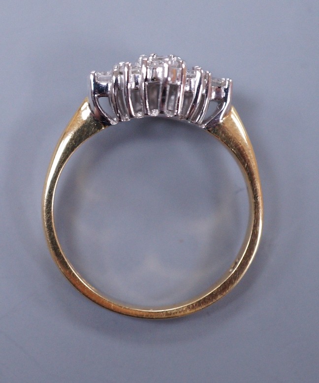 A modern 18ct gold and nine stone diamond set shaped cluster ring, size P, gross weight 4.3 grams
